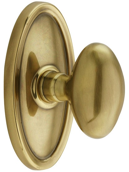 Oval Rosette Set With Elliptical Brass Knobs in Antique Brass.